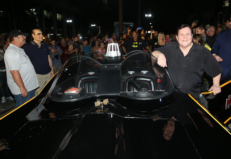 Burt Ward, who played Robin opposite West, with a Batmobile.